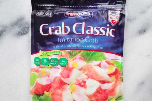 A bag of Trans-Ocean crab classic imitation crab on top of a marble board.