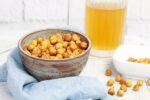 crispy spicy chickpeas in a bowl with a glass of frosty cold beer.
