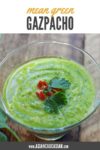 green gazpacho soup in a glass bowl on a wooden board