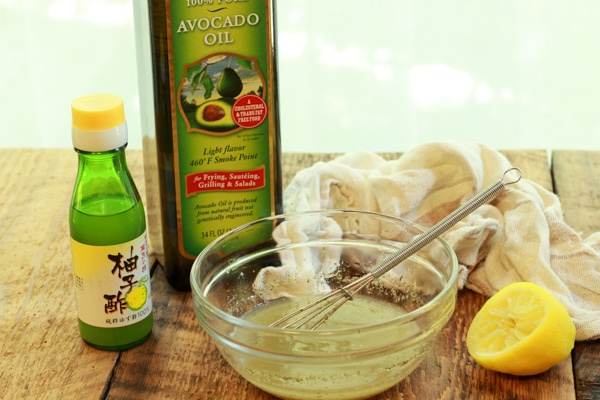 ingredients for making a yuzu vinaigrette on top of a wooden board