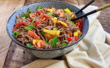 Colorful Japanese soba noodle salad in a large bowl with chopsticks
