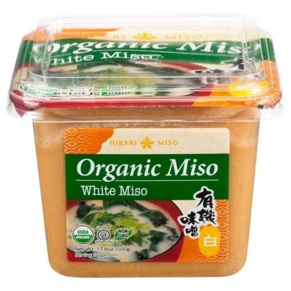 container of organic white miso on a white background