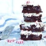 A stack of peppermint brownies on a white surface