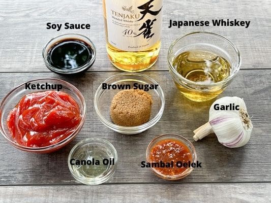 Ingredients for making Japanese whiskey sauce for chicken wings, on a wooden board