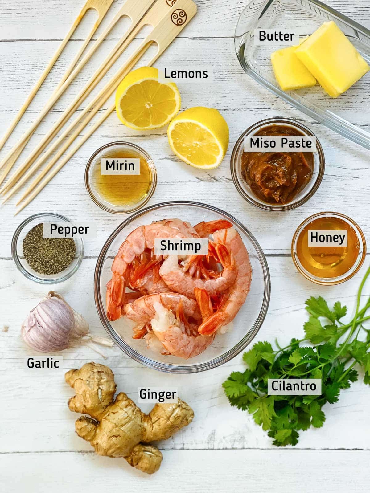 Labeled ingredients for making shrimp with miso sauce on top of a white board.
