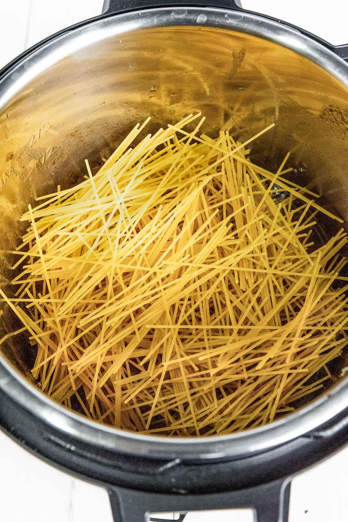 Spaghetti noodles inside an Instant Pot ready to be cooked.