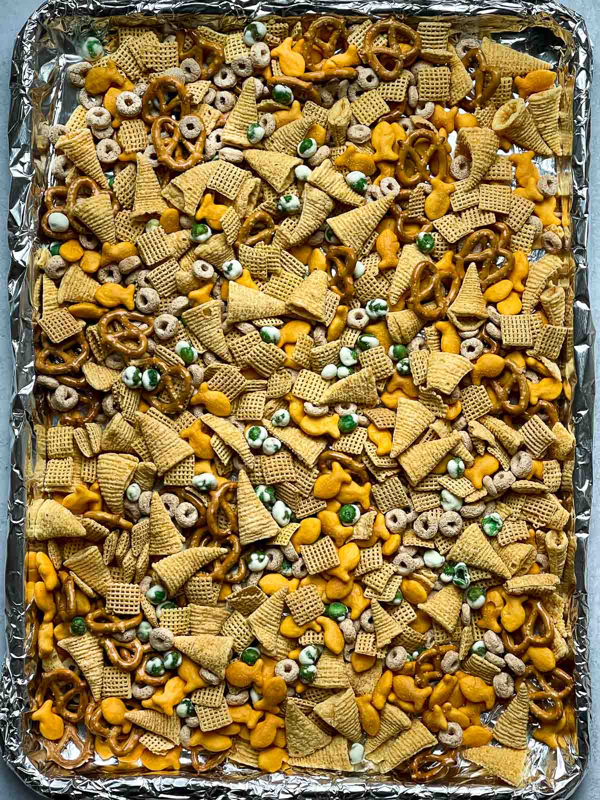 A baking tray lined with Furikake Chex Mix before baking.