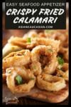 Fried and crispy calamari rings on a wooden board with lemon wedges on the side.