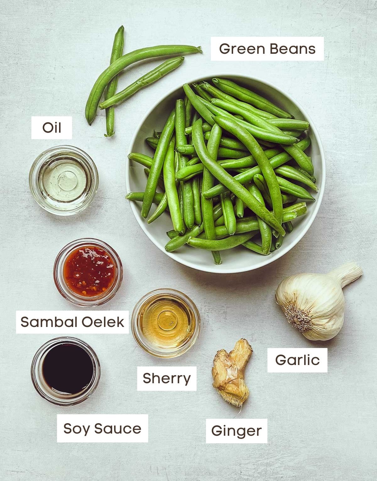 Labeled ingredients in small bowls for making Chinese Garlic Green Beans.